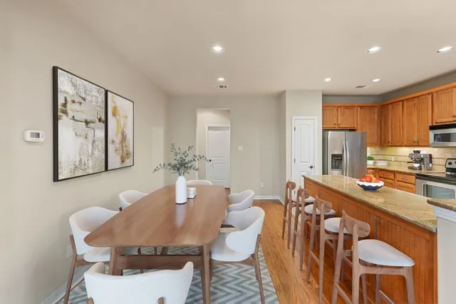 a dining room with furniture a window and kitchen view