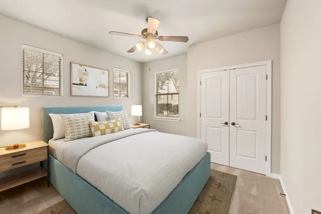 a bedroom with a large bed and a chandelier