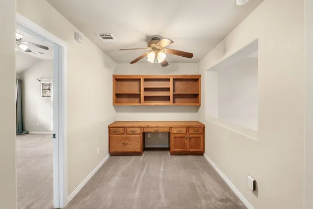 a view of room with staircase and ceiling fan