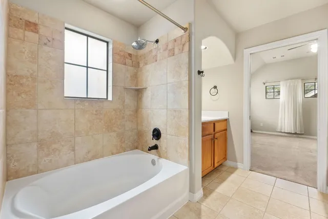 a bathroom with a bathtub and a shower