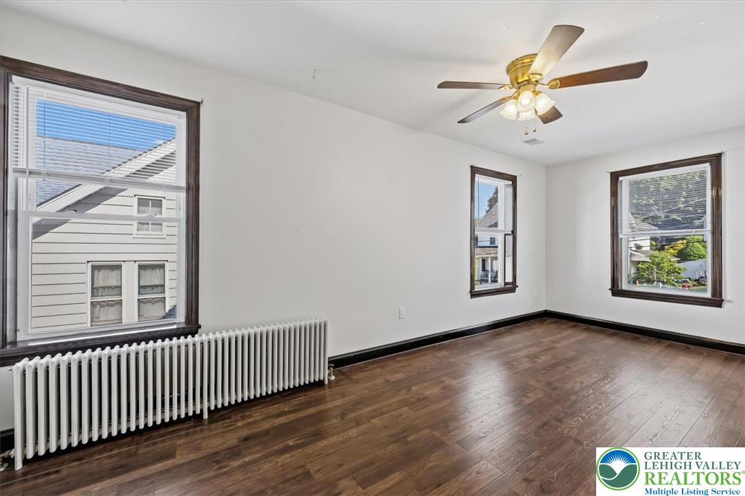 3453 Main Street Slatington, PA 18080 - Photo 11 of 30 Hardwood floors and a ceiling fan create a comfortable atmosphere in this inviting room.