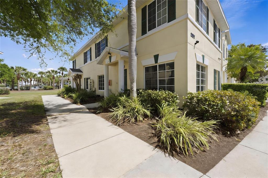 257 Cape Harbour Loop, Unit 101 Bradenton, FL 34212 - Photo 1 of 1 a view of a white house with a yard and potted plants