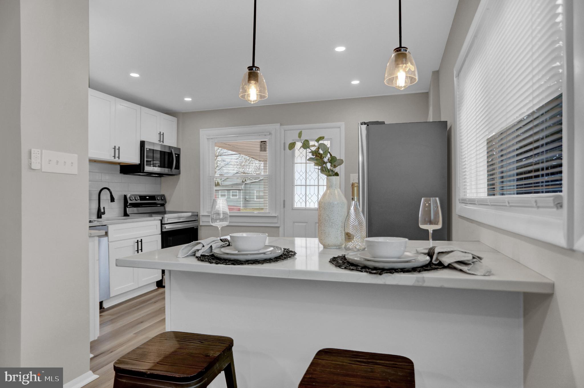 1407 3rd Road Middle River, MD 21220 - Photo 5 of 20 a kitchen with kitchen island granite countertop stainless steel appliances and a sink