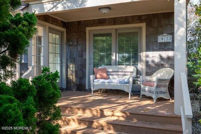a view of a two couches in the patio and a fire pit