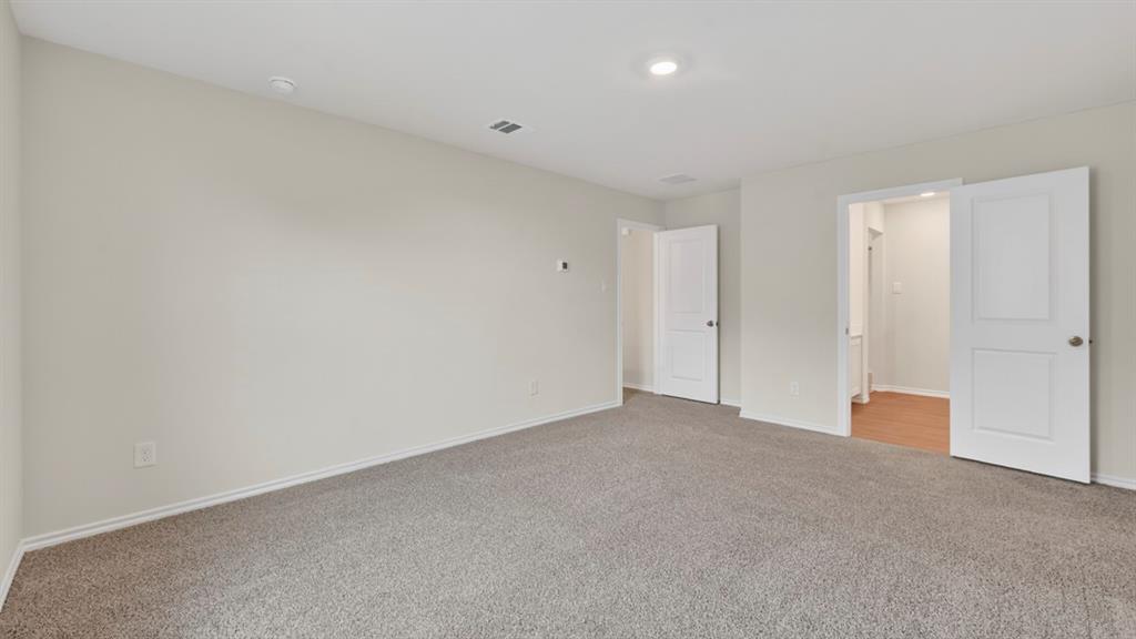 3534 Spring Time Street Forney, TX 75126 - Photo 10 of 24 Spacious room featuring neutral wall paint, gray carpet flooring, recessed lighting, and two panel doors
