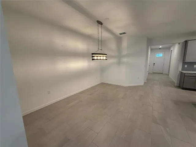 a view of a hallway with a cabinet