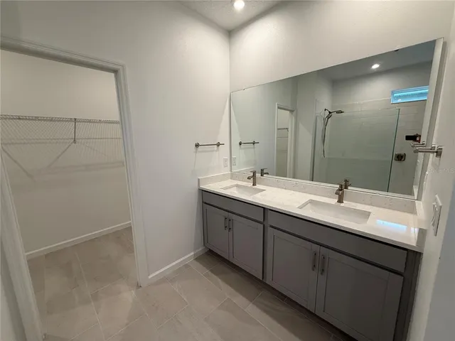 a bathroom with a double vanity sink and a mirror