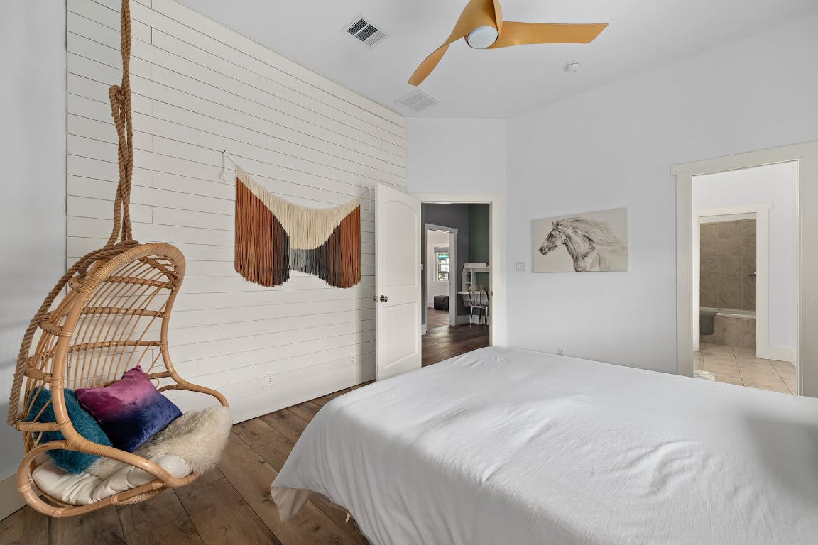 2001 Mestena Trail Austin, TX 78733 - Photo 19 of 40 a bedroom with a bed and a painting on the wall