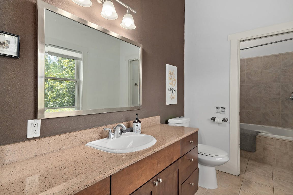 2001 Mestena Trail Austin, TX 78733 - Photo 22 of 40 a bathroom with a granite countertop sink toilet and shower