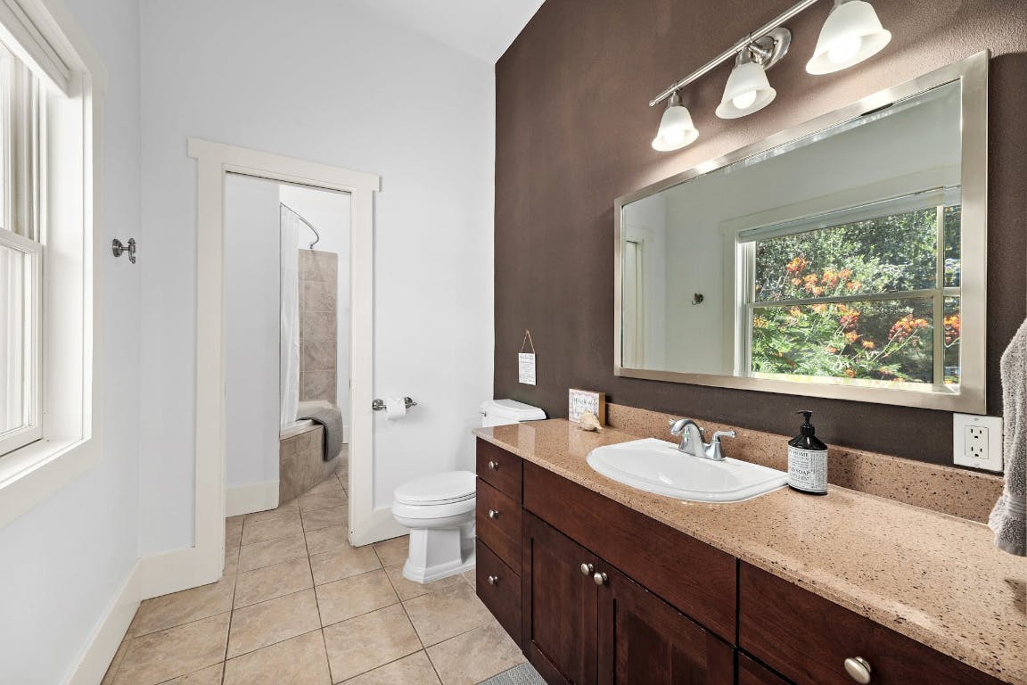 2001 Mestena Trail Austin, TX 78733 - Photo 23 of 40 a bathroom with a granite countertop sink mirror and a toilet