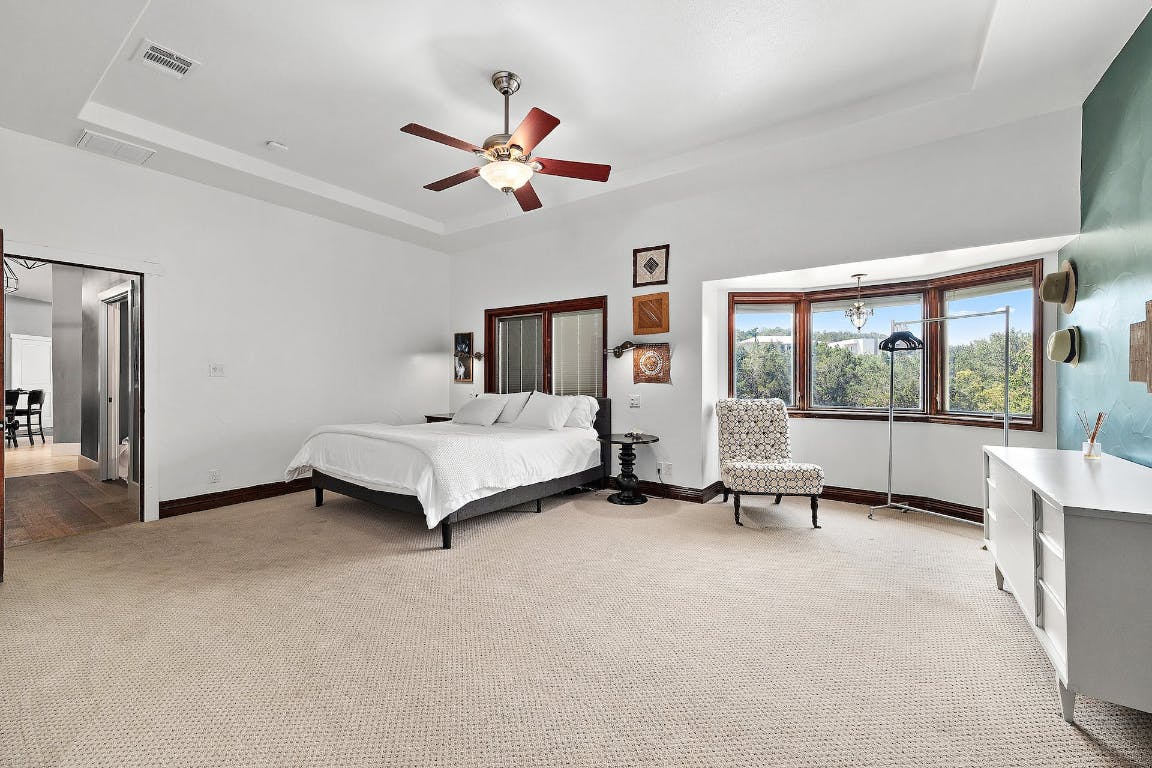 2001 Mestena Trail Austin, TX 78733 - Photo 31 of 40 a bed room with a bed and a large window