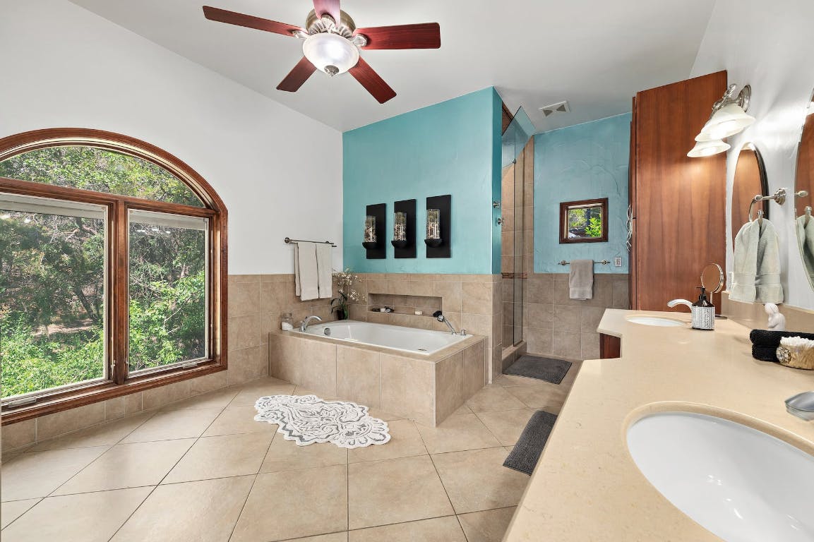 2001 Mestena Trail Austin, TX 78733 - Photo 33 of 40 a bathroom with a sink and a mirror