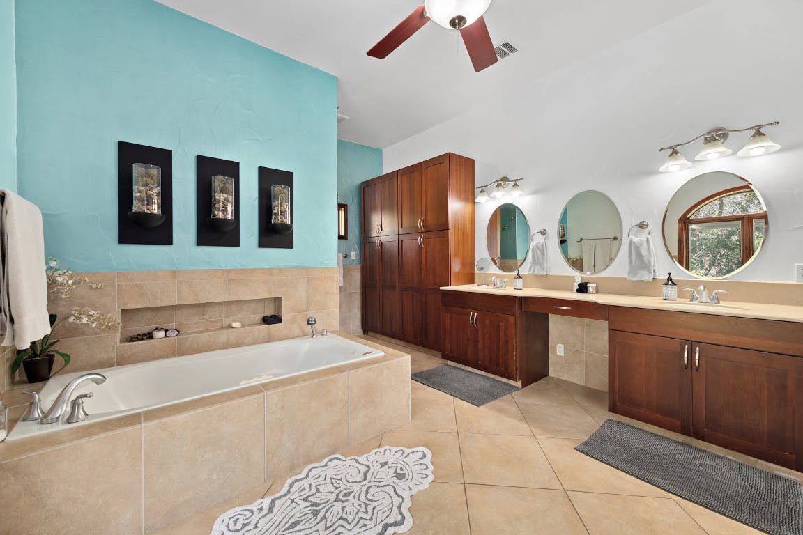 2001 Mestena Trail Austin, TX 78733 - Photo 34 of 40 a bathroom with a tub sink and mirror