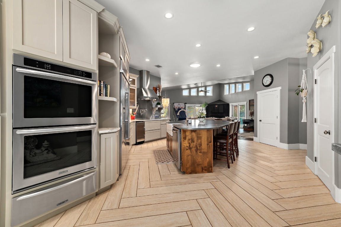 2001 Mestena Trail Austin, TX 78733 - Photo 8 of 40 a living room with stainless steel appliances kitchen island granite countertop a stove and a refrigerator