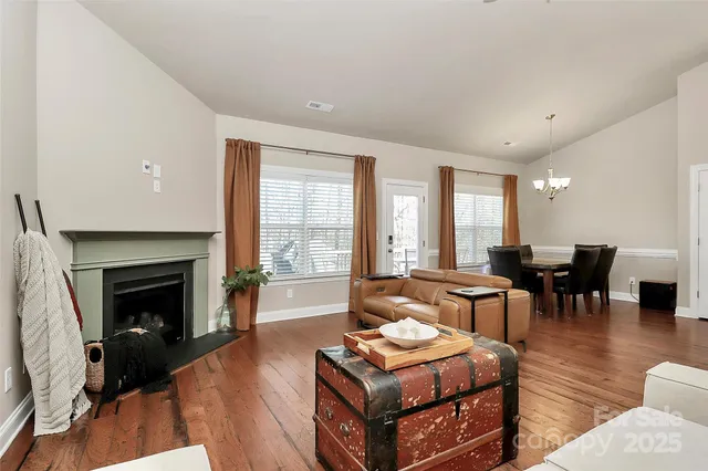 a living room with furniture a fireplace and a table