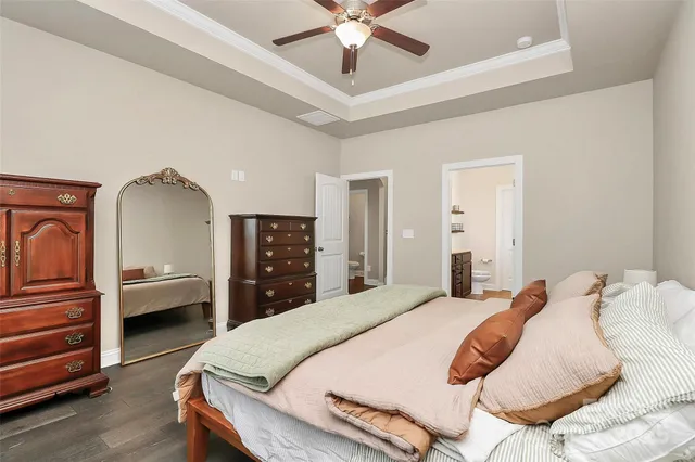 a bedroom with a bed and ceiling fan