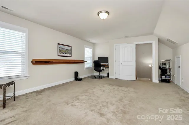 a view of a livingroom with furniture and a window