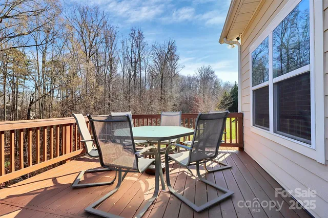 a view of a chairs and table on the balcony