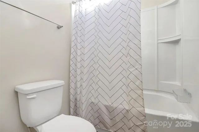 a white toilet sitting next to a white sink