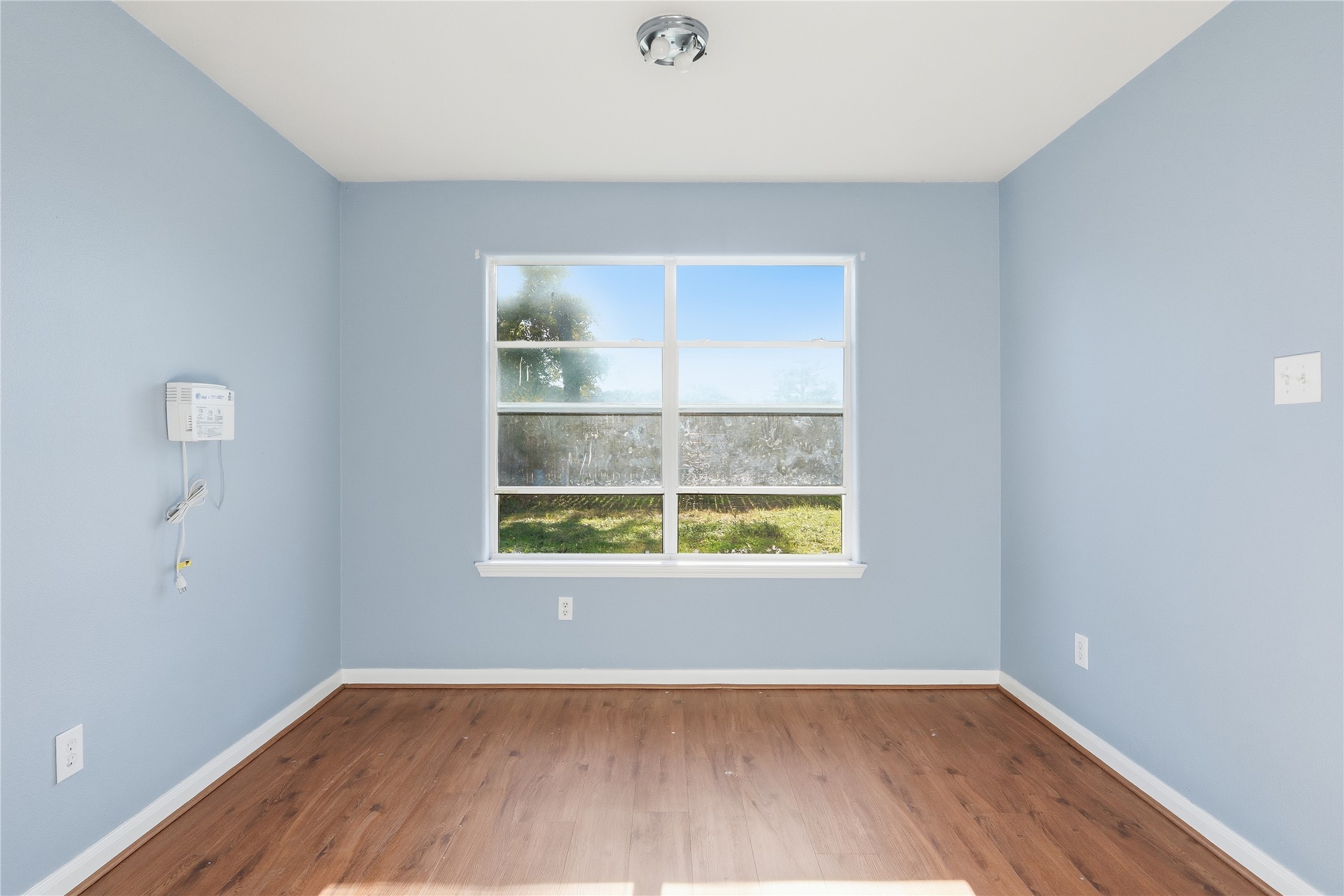 28807 Trinity River Drive Spring, TX 77386 - Photo 11 of 28 an empty room with wooden floor and windows