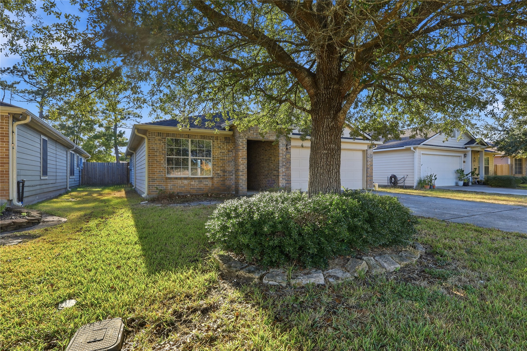 28807 Trinity River Drive Spring, TX 77386 - Photo 3 of 28 a view of a house with a small yard and large tree