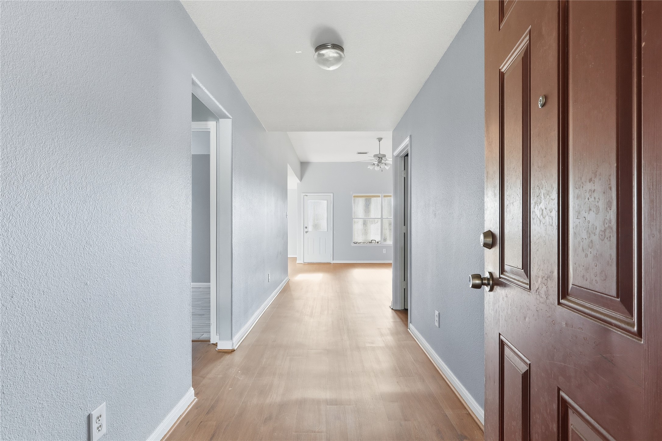 28807 Trinity River Drive Spring, TX 77386 - Photo 4 of 28 a view of a hallway with wooden floor and closet area