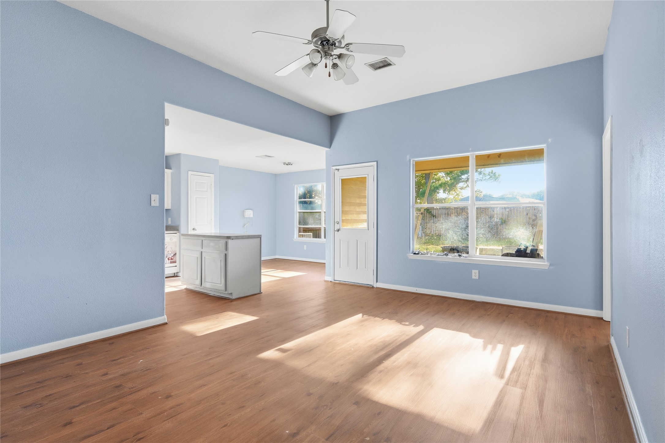 28807 Trinity River Drive Spring, TX 77386 - Photo 6 of 28 a view of an empty room with window and wooden floor