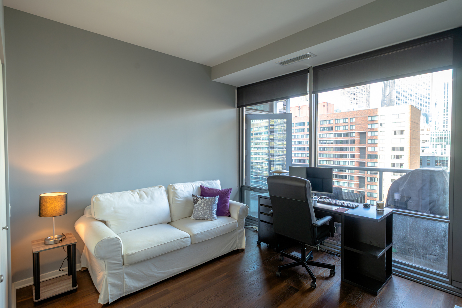 240 East Illinois Street, Unit 1606 Chicago, IL 60611 - Photo 13 of 22 a living room with furniture and a large window