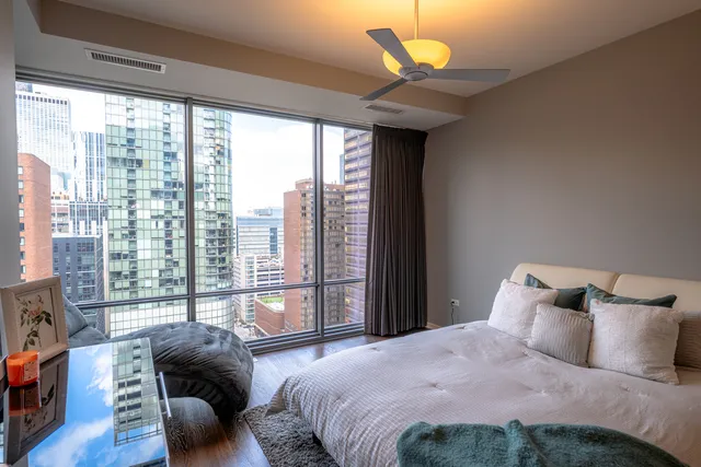 a bedroom with a bed and a large window