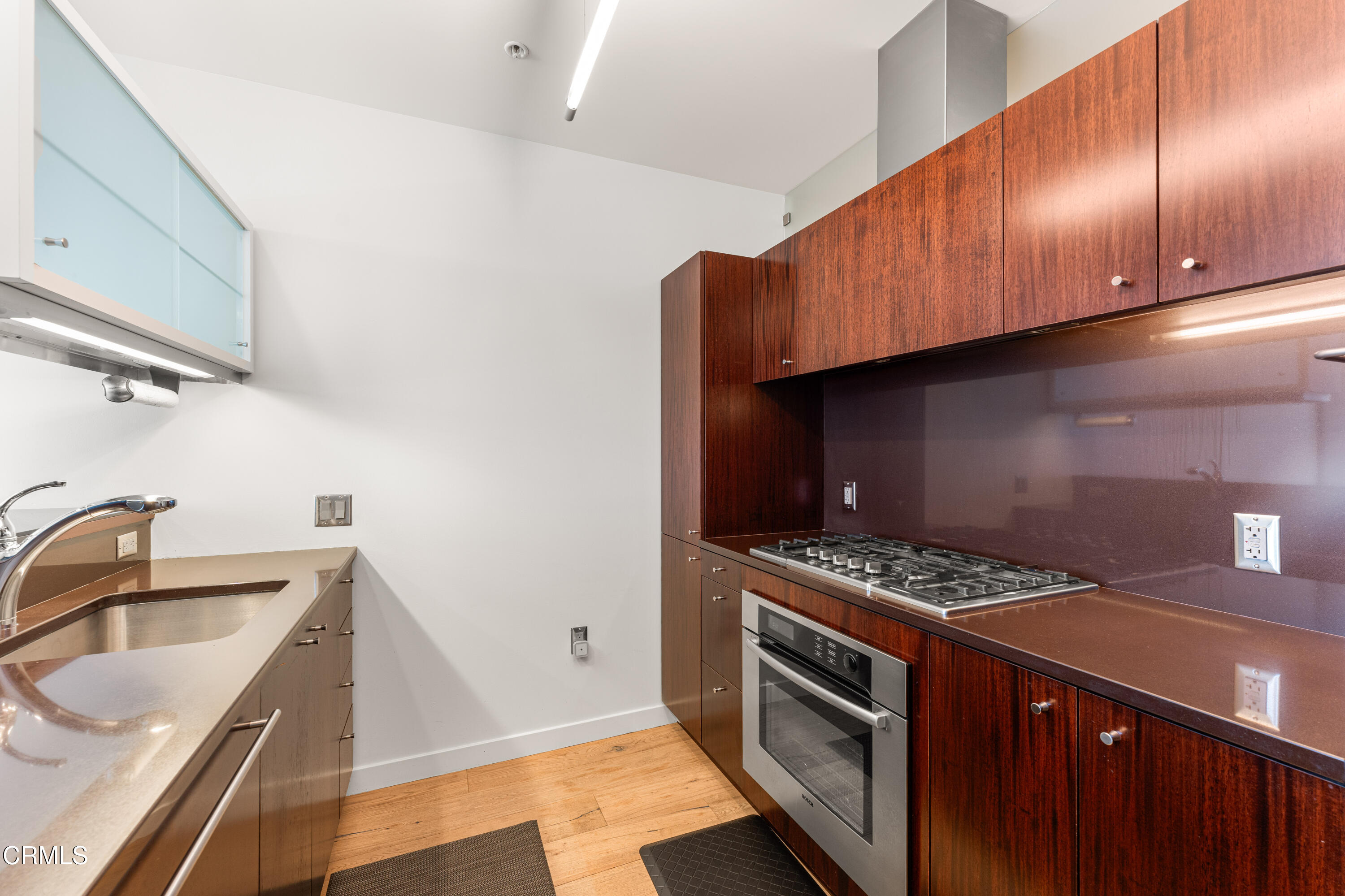 1155 South Grand Avenue, Unit 2106 Los Angeles, CA 90015 - Photo 11 of 51 a kitchen that has a sink and a stove