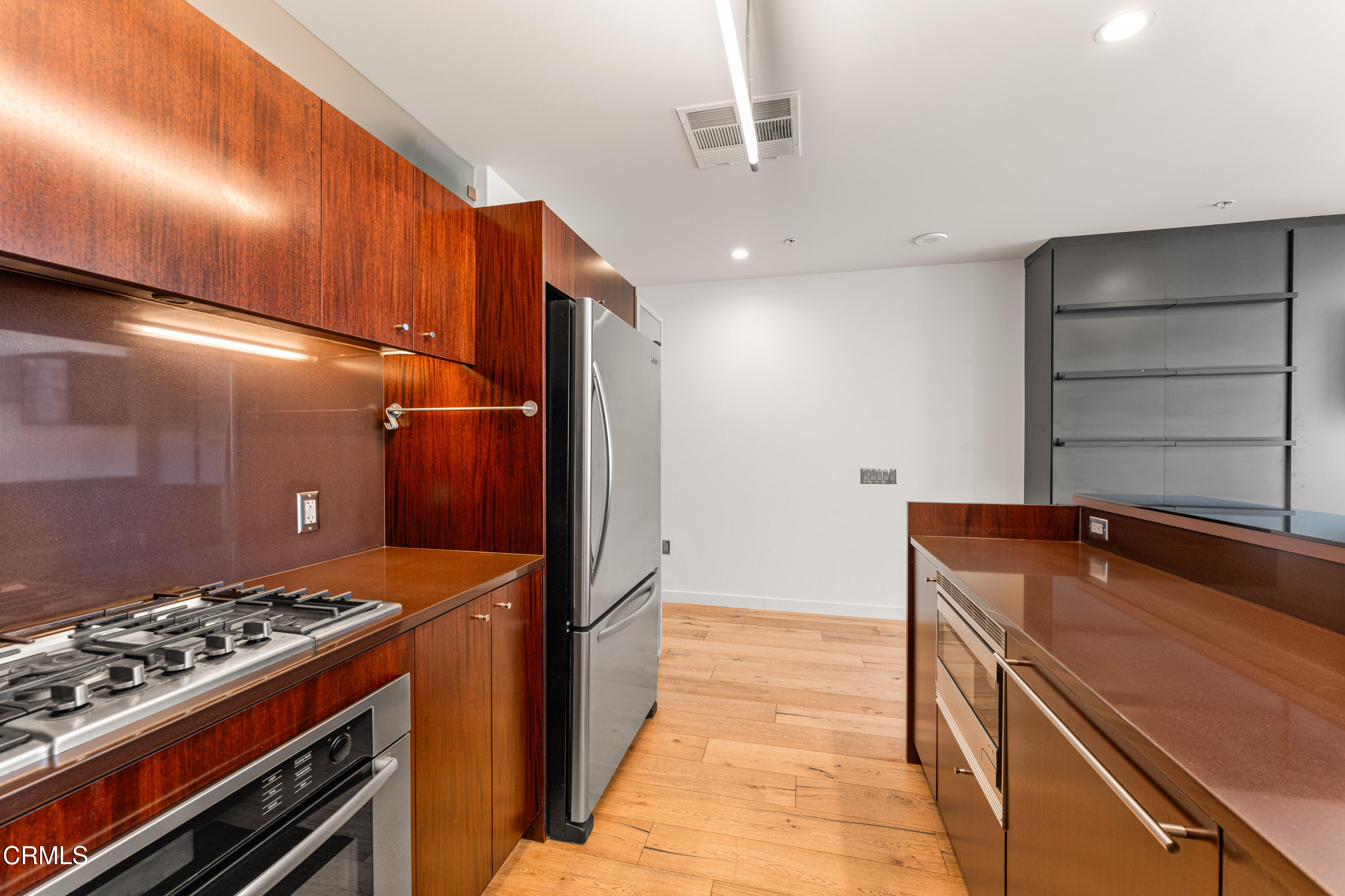 1155 South Grand Avenue, Unit 2106 Los Angeles, CA 90015 - Photo 12 of 51 a kitchen with a stove and a refrigerator