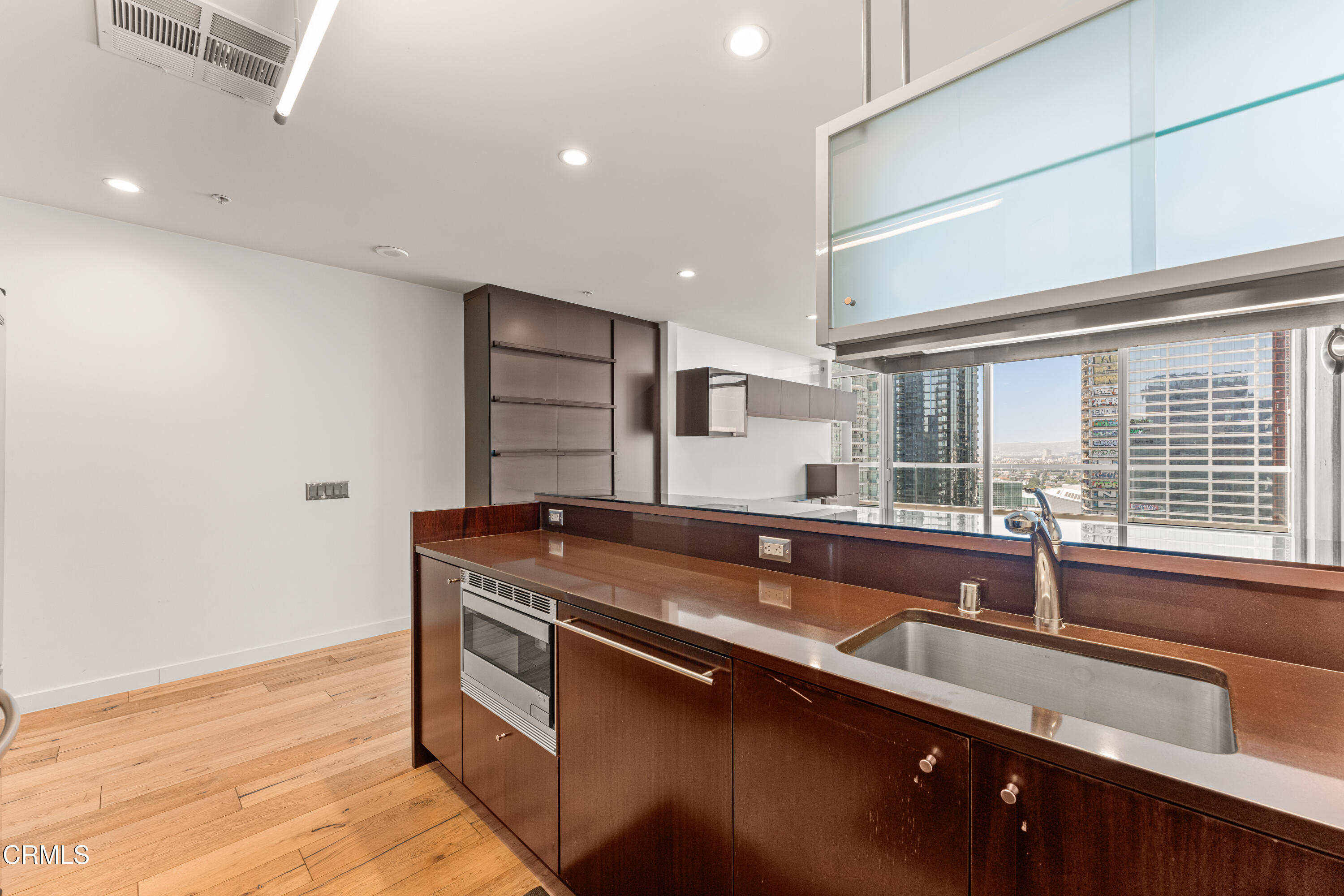 1155 South Grand Avenue, Unit 2106 Los Angeles, CA 90015 - Photo 13 of 51 a kitchen with stainless steel appliances granite countertop a sink and a stove