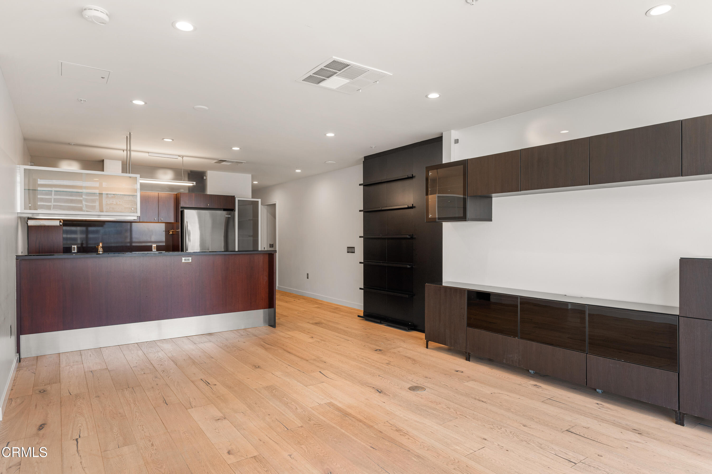 1155 South Grand Avenue, Unit 2106 Los Angeles, CA 90015 - Photo 15 of 51 a large kitchen with stainless steel appliances kitchen island a refrigerator sink and cabinets