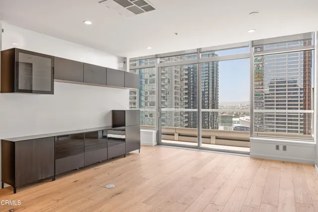 a view of a livingroom with a furniture and floor to ceiling window