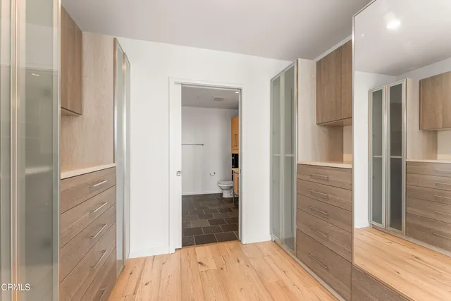 a view of walk in closet with empty racks