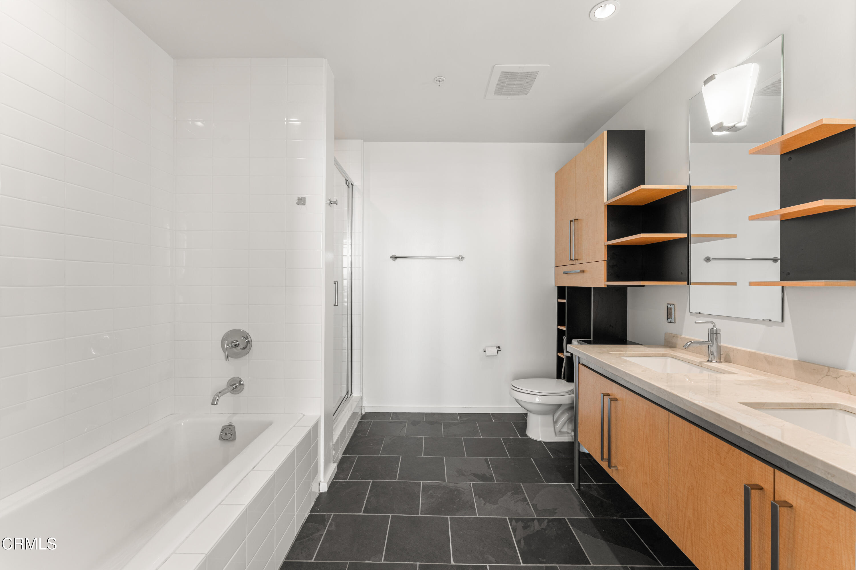1155 South Grand Avenue, Unit 2106 Los Angeles, CA 90015 - Photo 25 of 51 a bathroom with a granite countertop toilet a sink and bathtub
