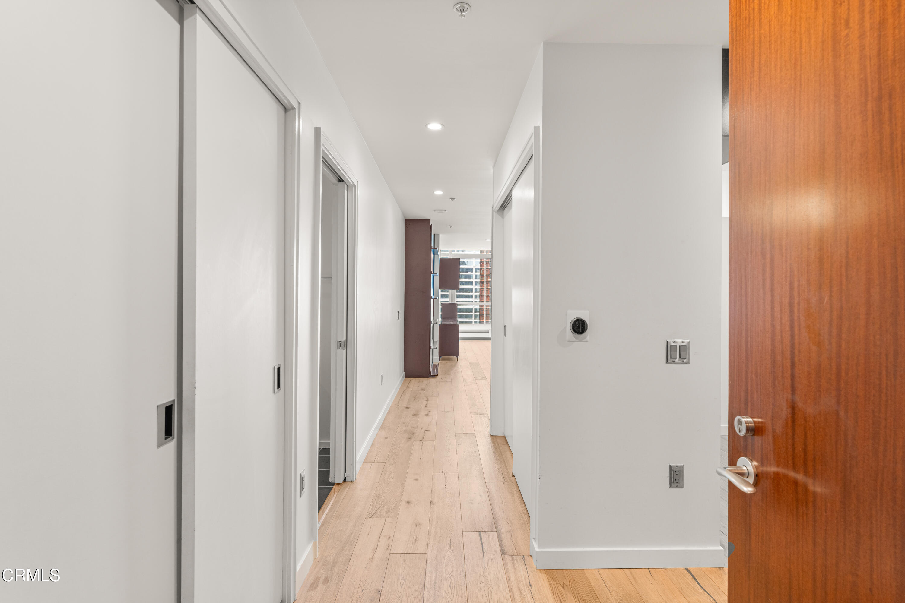 1155 South Grand Avenue, Unit 2106 Los Angeles, CA 90015 - Photo 3 of 51 a view of a hallway with wooden floor and staircase