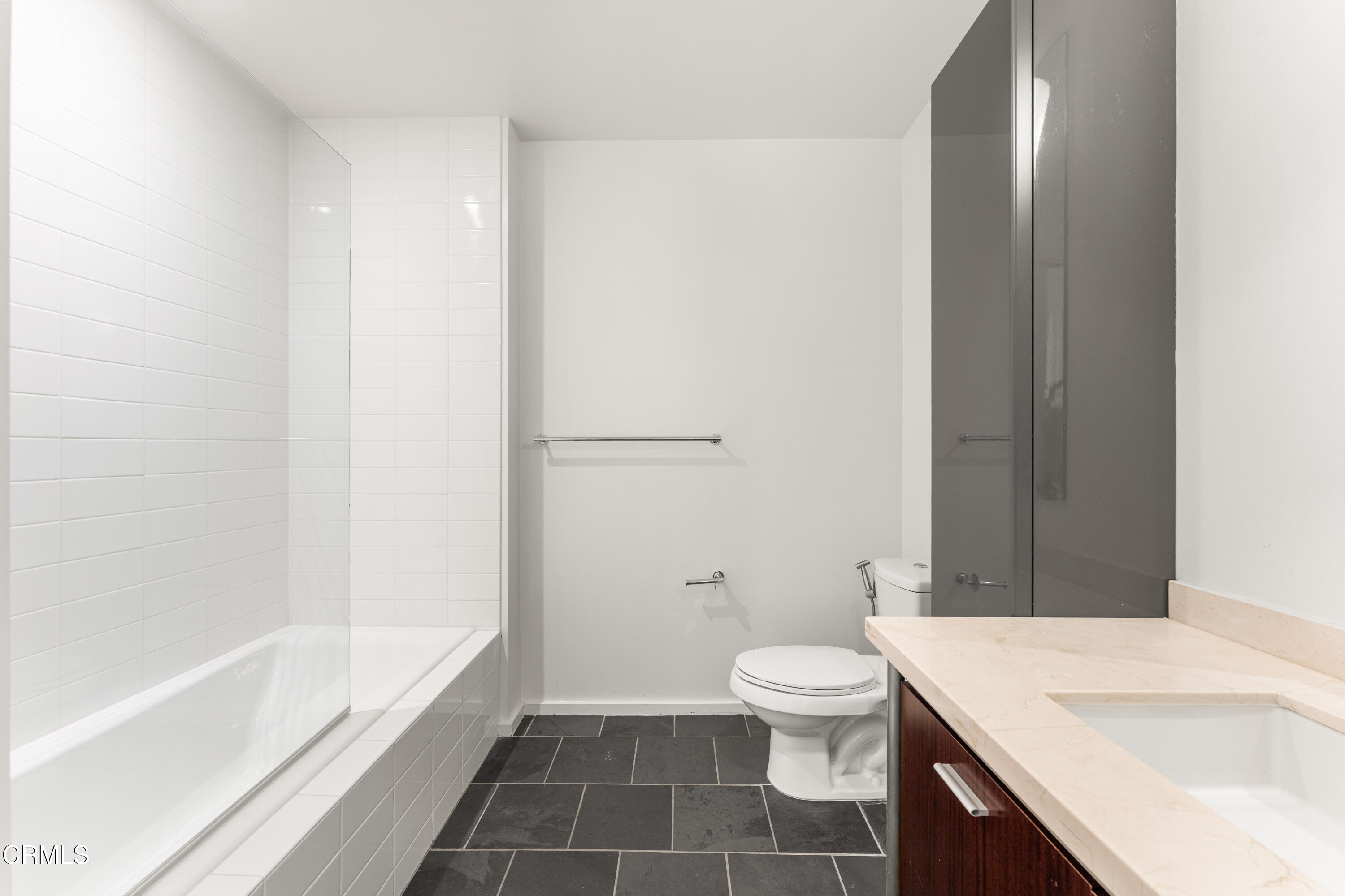 1155 South Grand Avenue, Unit 2106 Los Angeles, CA 90015 - Photo 31 of 51 a bathroom with a sink a toilet and shower