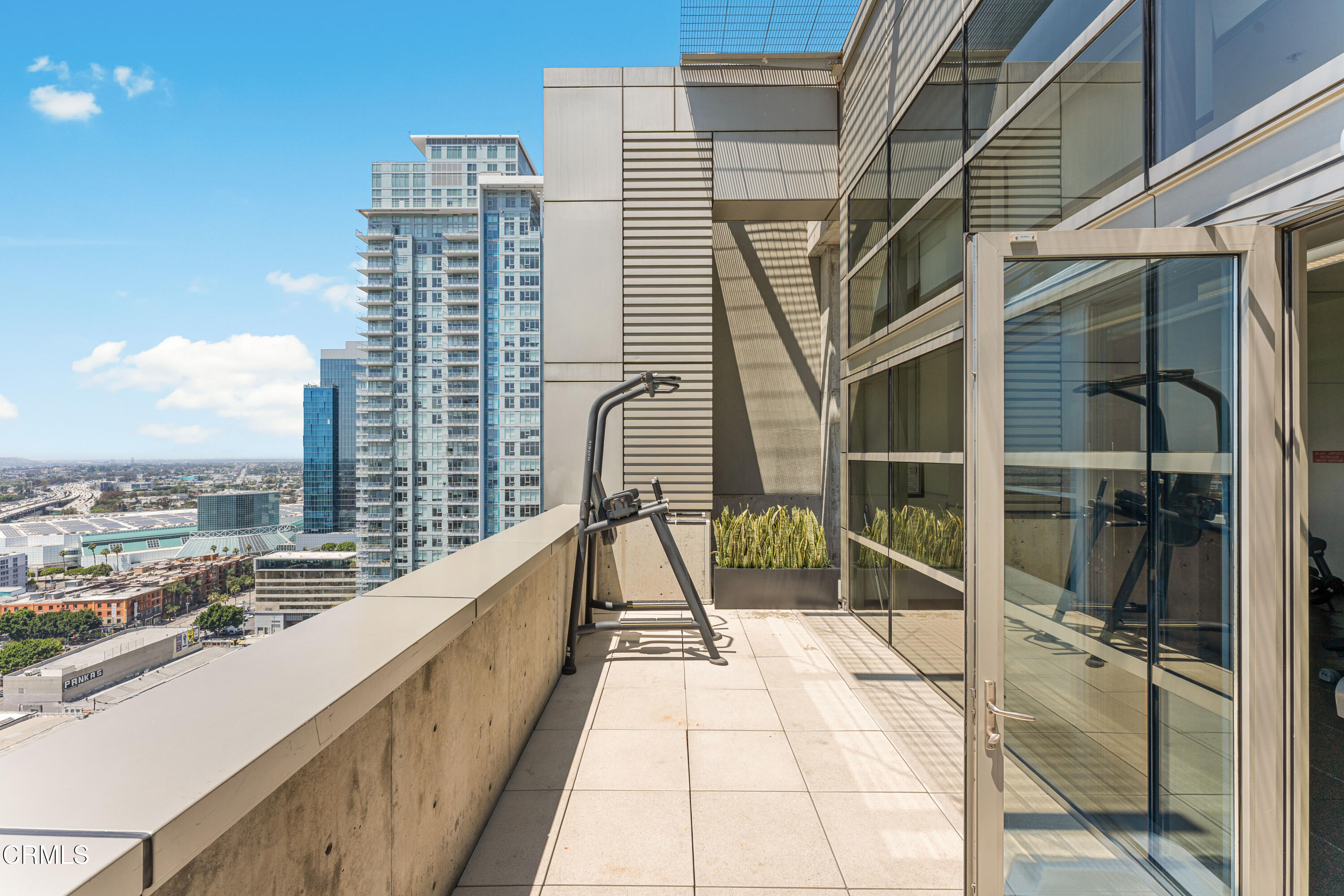 1155 South Grand Avenue, Unit 2106 Los Angeles, CA 90015 - Photo 37 of 51 a view of balcony with a large window and brick wall