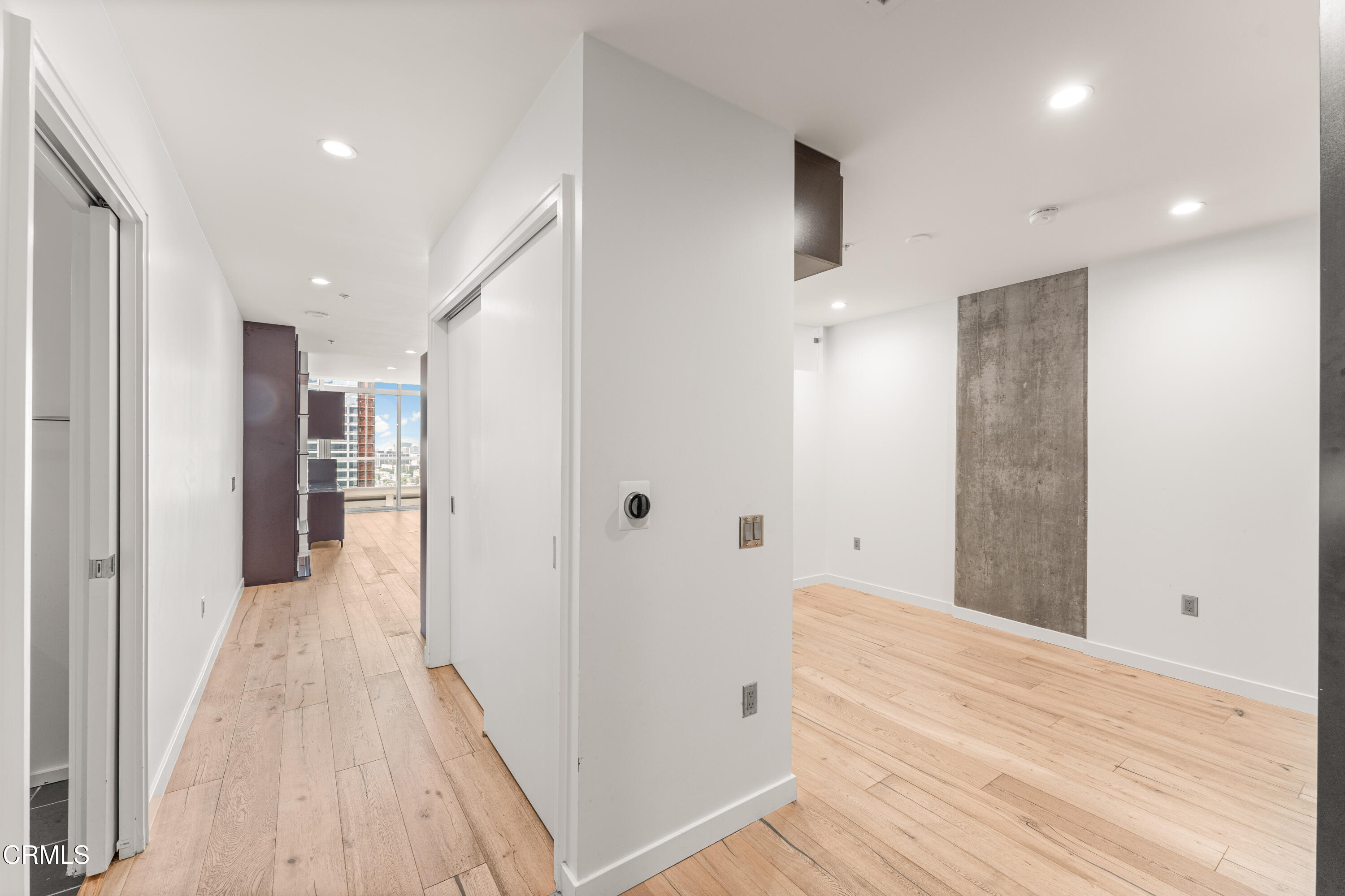 1155 South Grand Avenue, Unit 2106 Los Angeles, CA 90015 - Photo 4 of 51 a view of a hallway with wooden floor and staircase