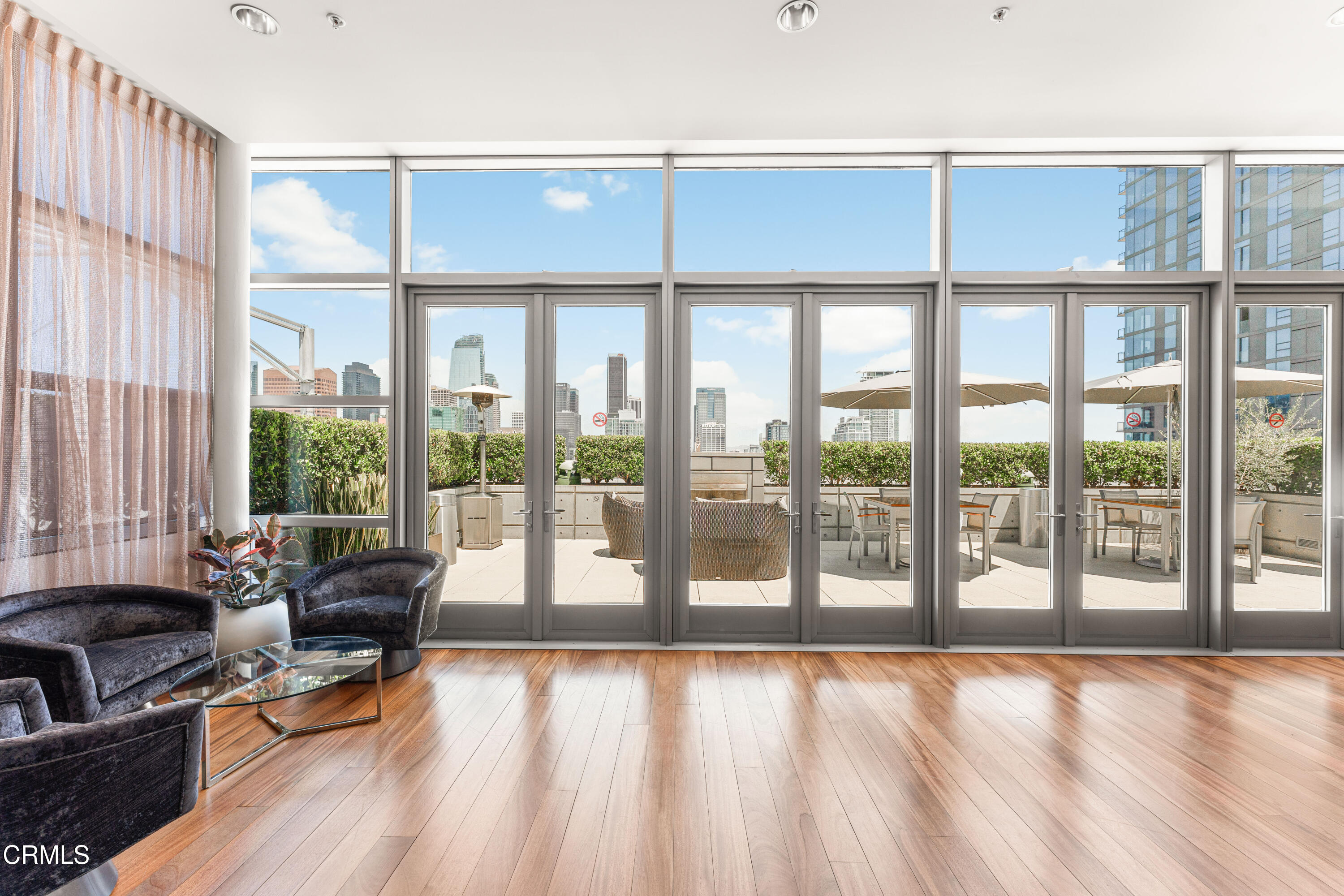 1155 South Grand Avenue, Unit 2106 Los Angeles, CA 90015 - Photo 44 of 51 a living room with furniture and floor to ceiling windows