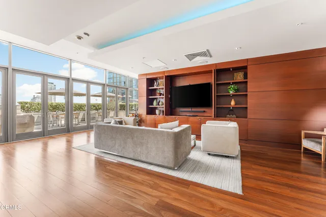 a hallway with a large window and dining area