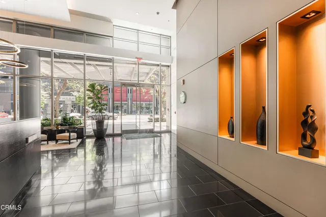 a living room with patio furniture and a large window