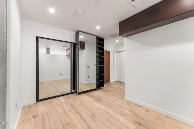 a view of hallway with wooden floor
