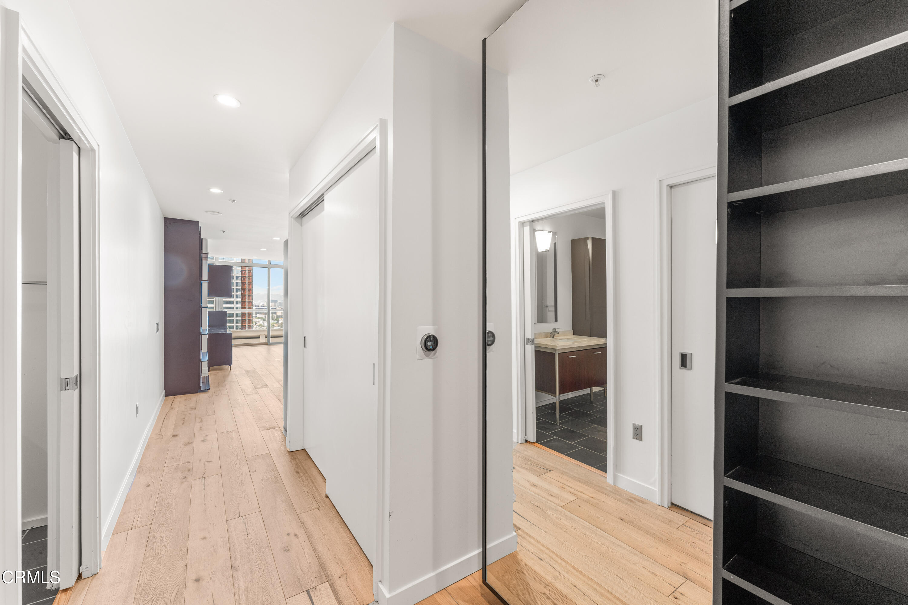 1155 South Grand Avenue, Unit 2106 Los Angeles, CA 90015 - Photo 8 of 51 a view of a hallway with wooden floor and closet