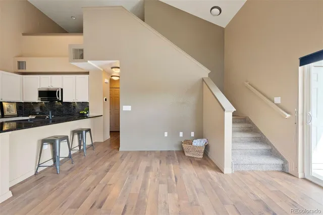 a view of entryway and hall with wooden floor