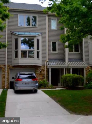 a car parked in front of a brick house