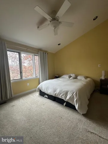 a large bed sitting in a room next to a window