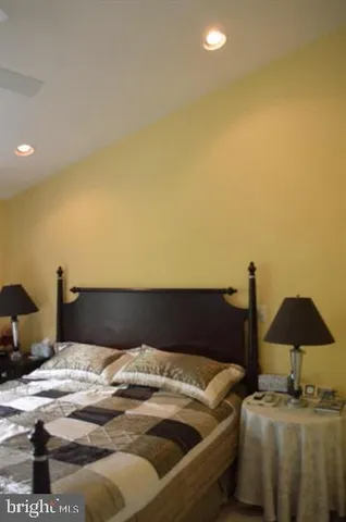 a bedroom with a bed and a lamp