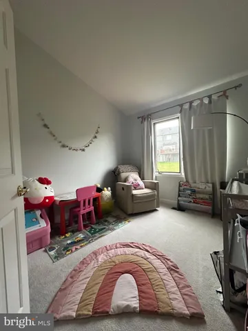 a bedroom with bed and a window